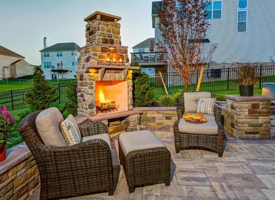 Outdoor-living-area-with-fireplace-and-wicker-chairs