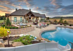 Large modern backyard with stone and swimming pool