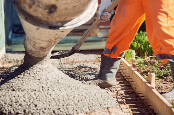 Spreading concrete on patio by contractor