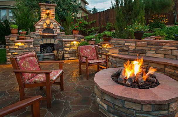 Lit stone firepit on patio at night