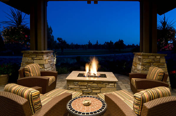 "Stone patio with stone fire pit"