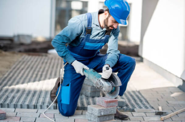 Contractor installing brick paving