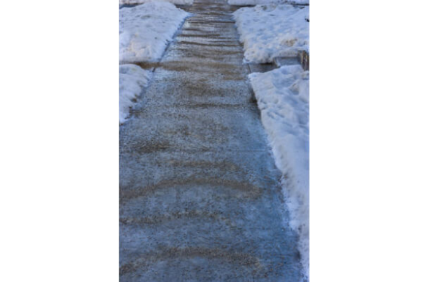 Rock salt covered sidewalk in winter