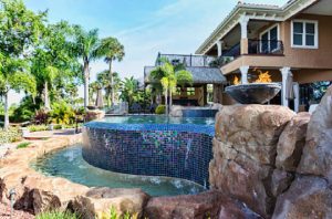 Boulders on landscaped yard with pool