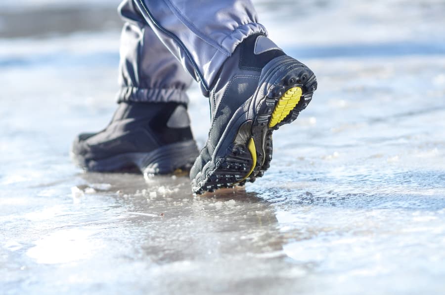 Pedestrian walking on treacherous icy walkway