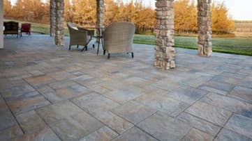 Outdoor area with stone floor and pillars and patio furniture