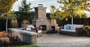 Outdoor patio with stone pavers, fireplace, and patio furniture