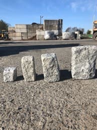 Belgium blocks of different sizes lined up on pavement