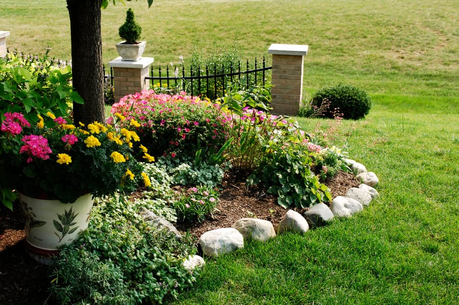 flower-garden-with-rock-border-next-to-grass Flower garden with rock border next to grass