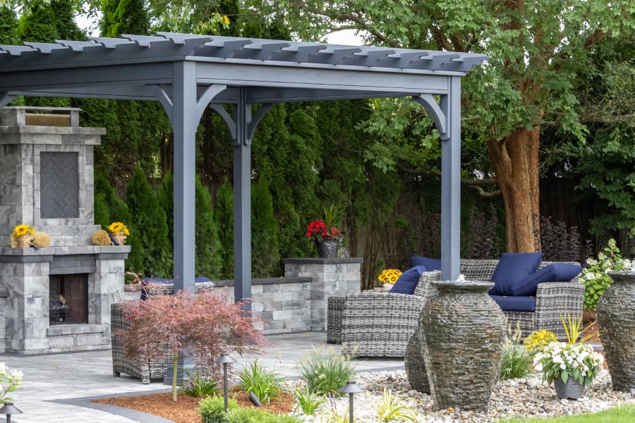 pergola-covering-outdoor-stone-fireplace-and-chairs Pergola covering outdoor stone fireplace and chairs