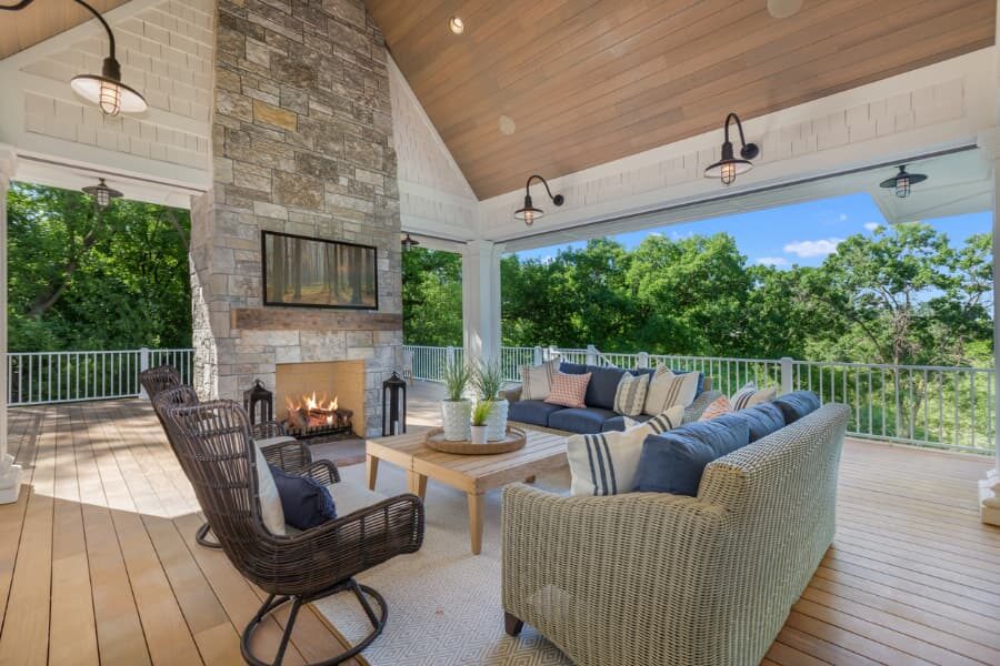 Large Outdoor Fireplace On Deck With Vaulted Ceiling And Furniture